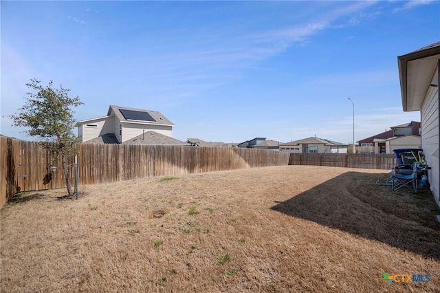 view of yard with a fenced backyard