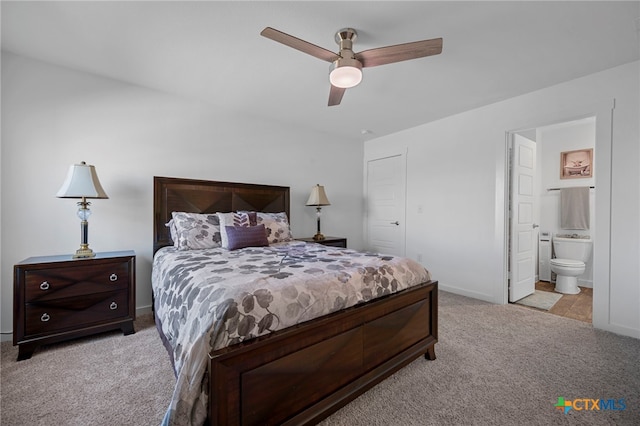 carpeted bedroom featuring ceiling fan, baseboards, and ensuite bathroom