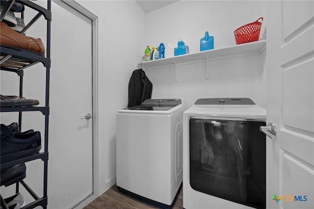 clothes washing area featuring laundry area, separate washer and dryer, and dark wood-type flooring