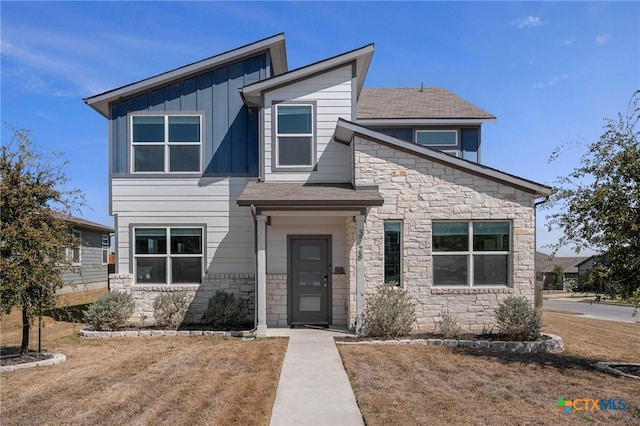 contemporary home featuring stone siding and board and batten siding