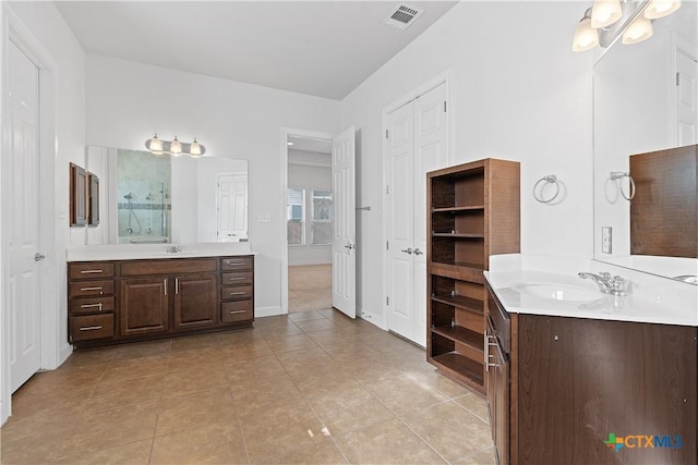 bathroom featuring tile patterned flooring, vanity, and a chandelier