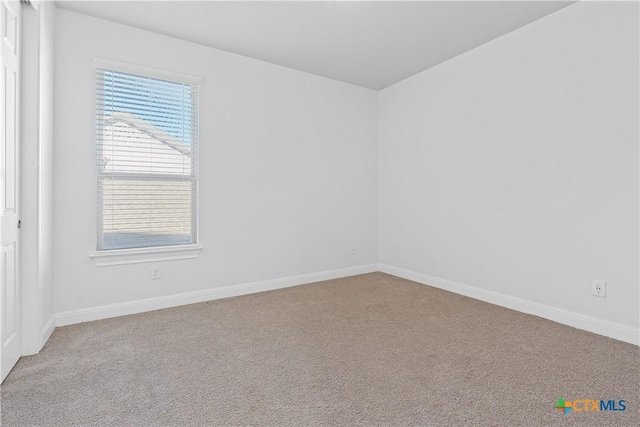 carpeted empty room with plenty of natural light