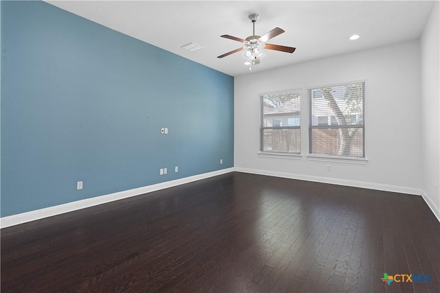 empty room featuring ceiling fan and dark wood-type flooring