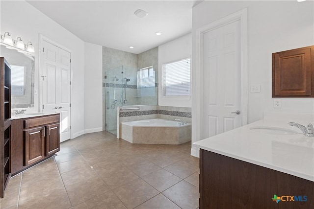 bathroom featuring tile patterned flooring, shower with separate bathtub, and vanity