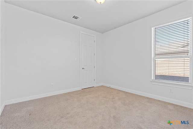 carpeted spare room with plenty of natural light