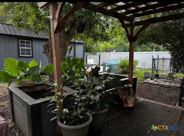212 Duggan St, Seguin, TX 78155 - view of patio / terrace with a garden and an outbuilding