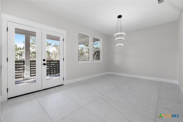 unfurnished dining area with french doors