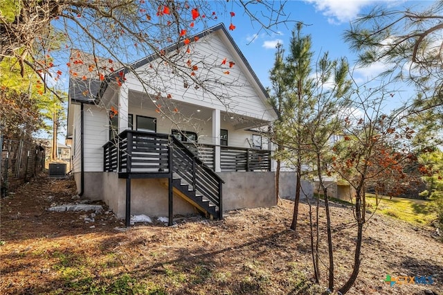 rear view of property featuring central air condition unit