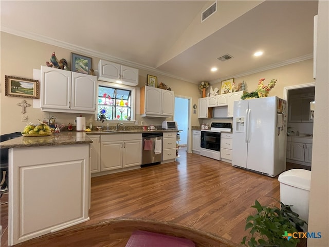 kitchen featuring white appliances, hardwood / wood-style flooring, and white cabinetry