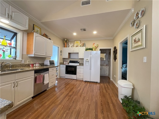 kitchen with white cabinets, white appliances, hardwood / wood-style flooring, and sink