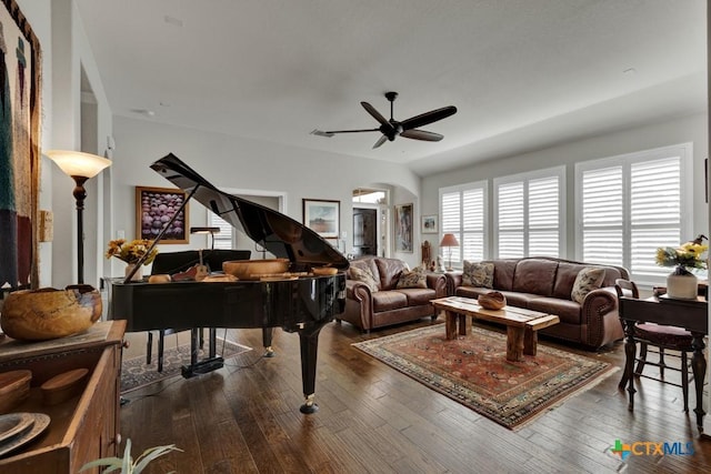 living room with ceiling fan and dark wood-type flooring