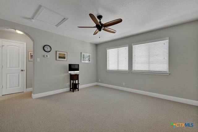 spare room featuring light carpet and ceiling fan