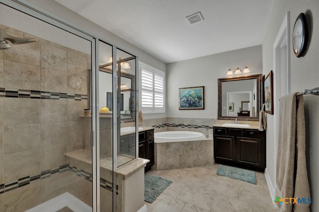 bathroom featuring vanity and separate shower and tub