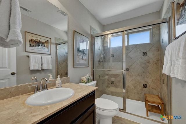 bathroom with vanity, toilet, and walk in shower