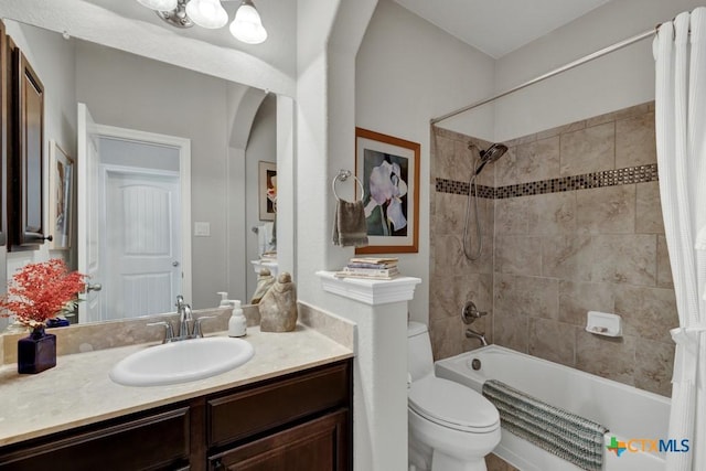 full bathroom featuring vanity, toilet, and shower / tub combo with curtain