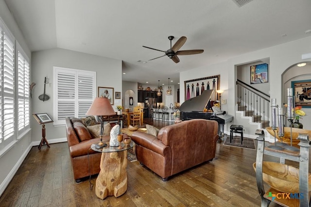 living room featuring hardwood / wood-style floors, vaulted ceiling, and ceiling fan