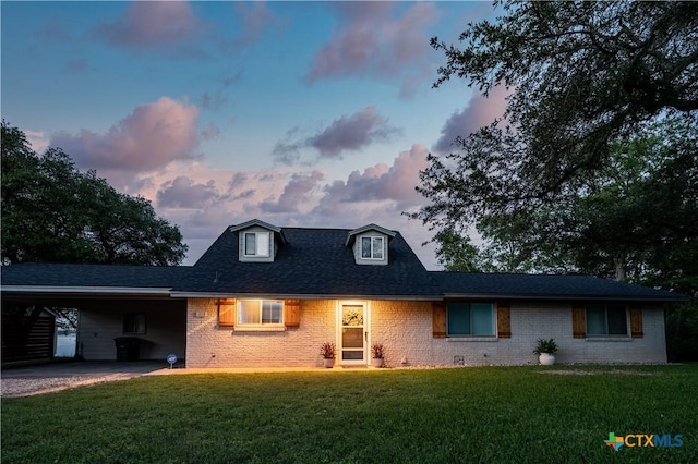 view of front of home featuring a carport and a lawn