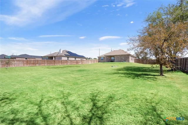 view of yard with a fenced backyard