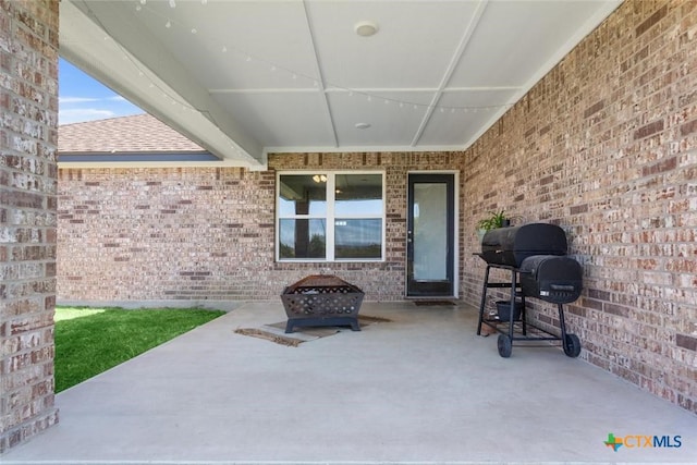 view of patio / terrace with a fire pit and area for grilling