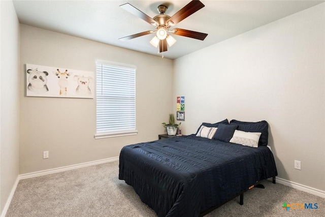 carpeted bedroom with ceiling fan and baseboards