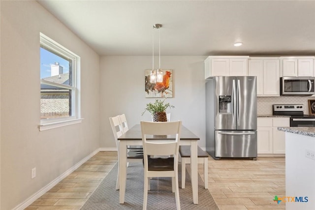 dining room featuring recessed lighting, light wood-type flooring, and baseboards