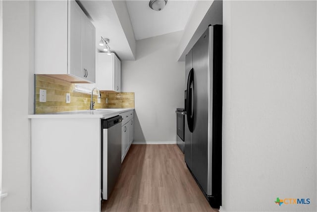1709 Bobby Lee Dr, Killeen, TX 76549 - kitchen with refrigerator with ice dispenser, stainless steel dishwasher, a sink, light wood finished floors, and light countertops