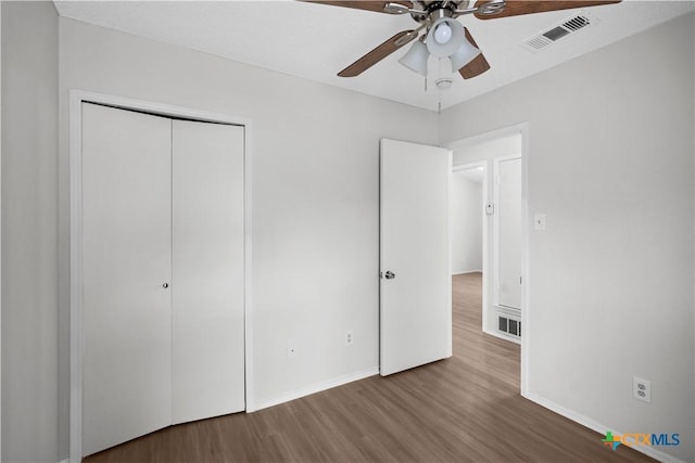 1709 Bobby Lee Dr, Killeen, TX 76549 - unfurnished bedroom with wood finished floors, baseboards, a closet, and a ceiling fan