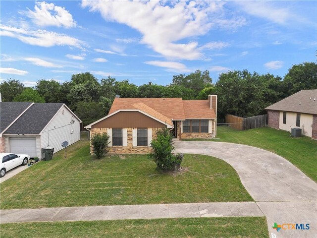 1709 Bobby Lee Dr, Killeen, TX 76549 - view of front of home with curved driveway, central AC unit, and a chimney