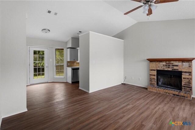 1709 Bobby Lee Dr, Killeen, TX 76549 - unfurnished living room with lofted ceiling, a ceiling fan, dark wood-type flooring, a brick fireplace, and baseboards