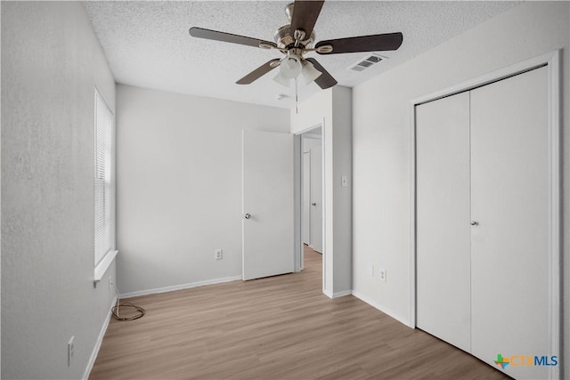 1709 Bobby Lee Dr, Killeen, TX 76549 - unfurnished bedroom featuring wood finished floors, a textured ceiling, a closet, ceiling fan, and baseboards