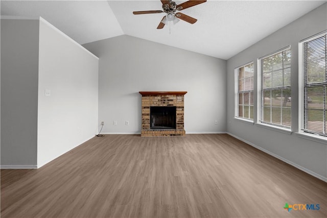 1709 Bobby Lee Dr, Killeen, TX 76549 - unfurnished living room featuring a ceiling fan, wood finished floors, a brick fireplace, vaulted ceiling, and baseboards