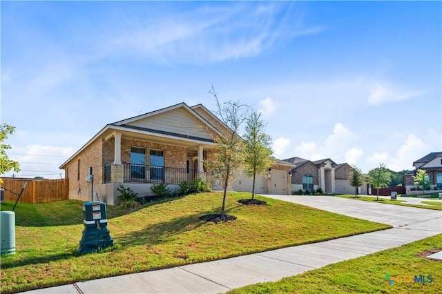 view of front of property with a garage, brick siding, fence, driveway, and a front lawn