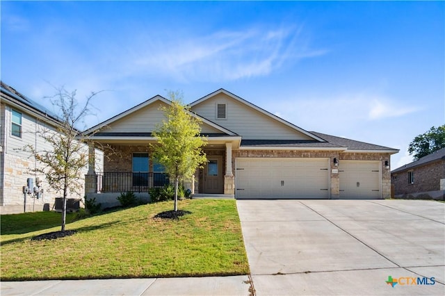 view of front of house featuring driveway, an attached garage, a front yard, a porch, and brick siding