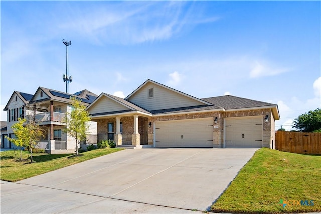 view of front of property with driveway, an attached garage, fence, and a front yard