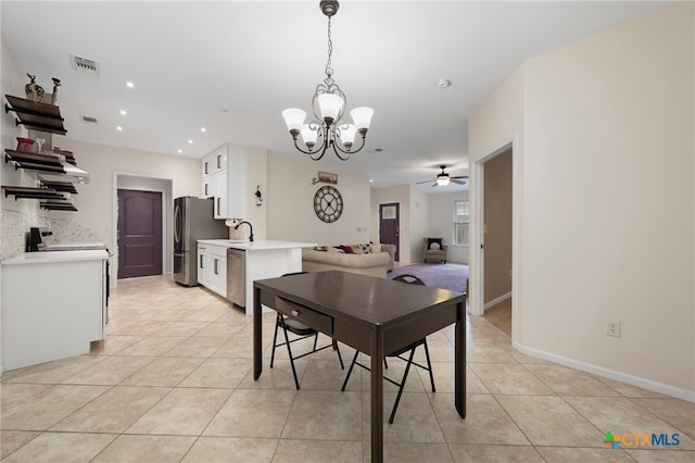 dining space with baseboards, visible vents, ceiling fan with notable chandelier, light tile patterned flooring, and recessed lighting