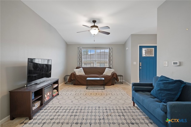 living room with light carpet, ceiling fan, and baseboards