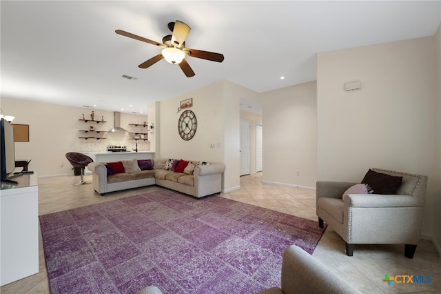 living room featuring light tile patterned flooring, recessed lighting, visible vents, a ceiling fan, and baseboards