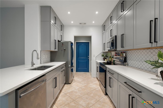 kitchen with recessed lighting, light countertops, visible vents, appliances with stainless steel finishes, and a sink