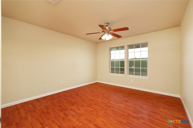 spare room with hardwood / wood-style floors and ceiling fan