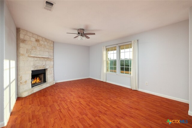 unfurnished living room featuring a fireplace, hardwood / wood-style flooring, and ceiling fan