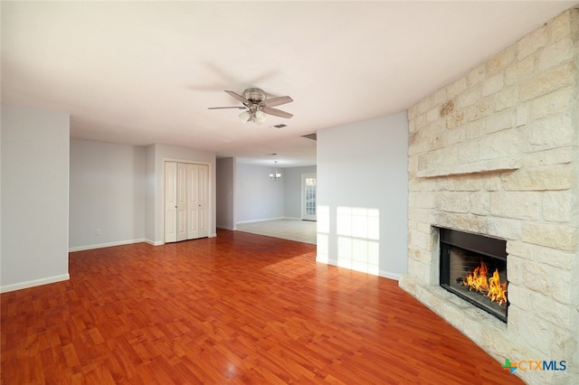 unfurnished living room with a fireplace, hardwood / wood-style flooring, and ceiling fan