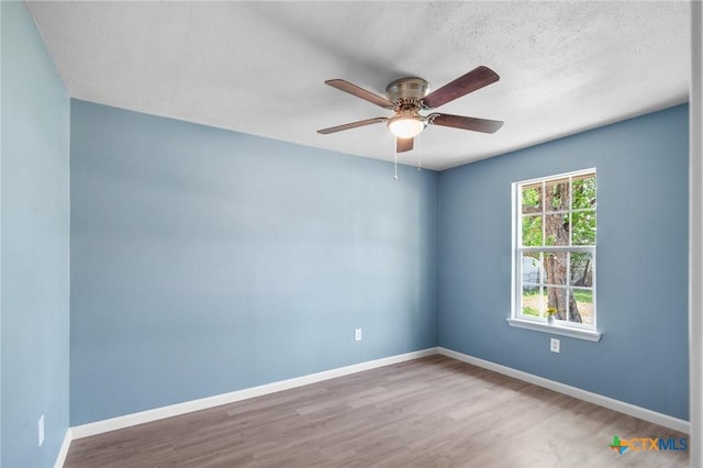 2603 Lone Tree Rd, Victoria, TX 77901 - unfurnished room featuring a ceiling fan, wood finished floors, baseboards, and a textured ceiling