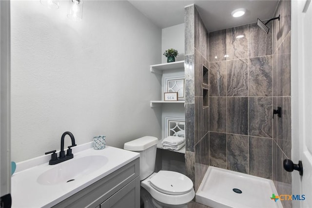 2603 Lone Tree Rd, Victoria, TX 77901 - bathroom with toilet, vanity, and a tile shower