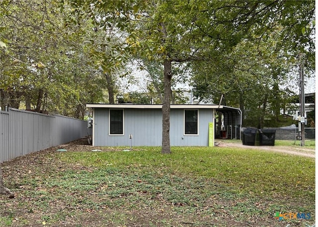 exterior space featuring a carport and a yard