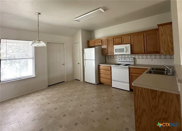 317 Janelle Dr, Copperas Cove, TX 76522 - kitchen featuring sink, tasteful backsplash, vaulted ceiling, pendant lighting, and white appliances