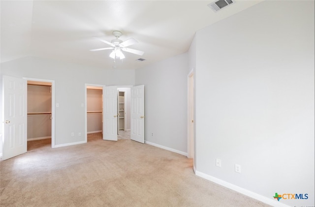 unfurnished bedroom with a ceiling fan, light colored carpet, visible vents, and baseboards