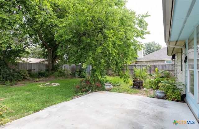 view of patio / terrace with a fire pit and a fenced backyard