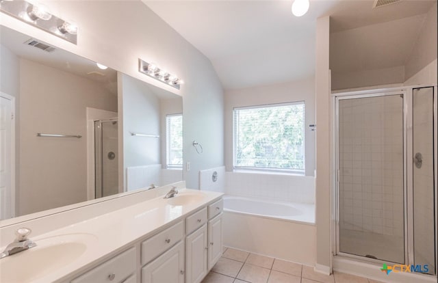 full bathroom with lofted ceiling, visible vents, a stall shower, a sink, and tile patterned floors