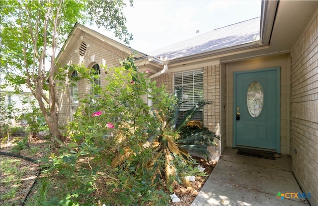 property entrance with brick siding