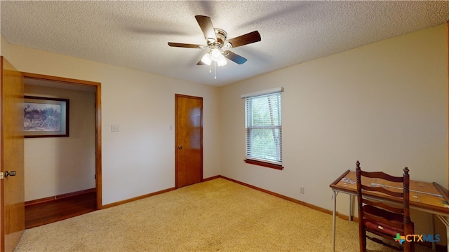 bedroom with carpet flooring, ceiling fan, and a textured ceiling